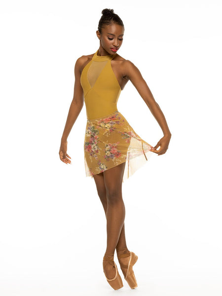 Model is wearing mustard yellow bodysuit with collared racerback and deep v mesh panel with matching yellow floral print skirt.