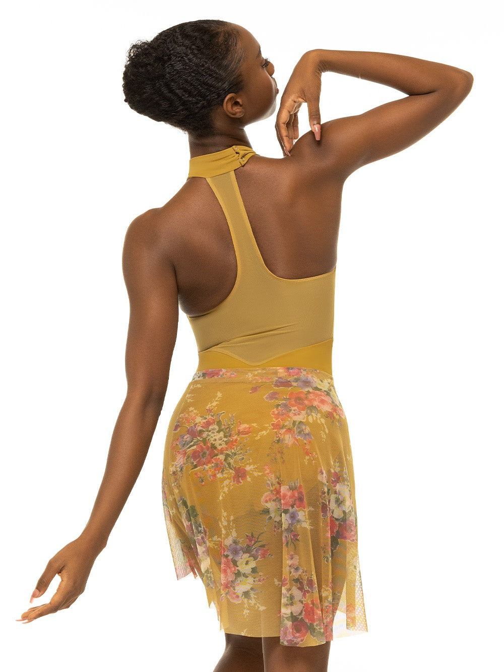 Back of model wearing mustard yellow bodysuit with a collar and mesh racerback with matching yellow floral print skirt.