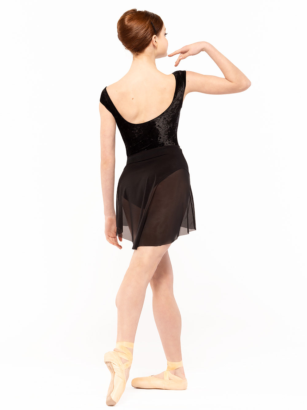 Dancer is facing back on tendu derriere and one hand on the shoulder,  wearing Sophia Leotard Black Crushed Velvet RTW.