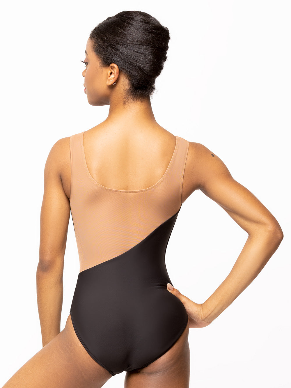 Back of model wearing black dance bodysuit with light brown nude mesh back, middle, and straps.