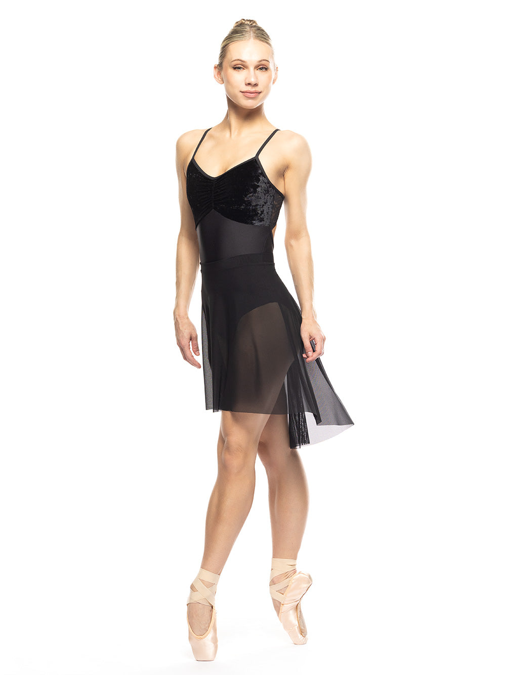 Dancer is facing diagonal front on four position on point with arms on the side, wearing a Back Tuck Skirt Black Mesh RTW.