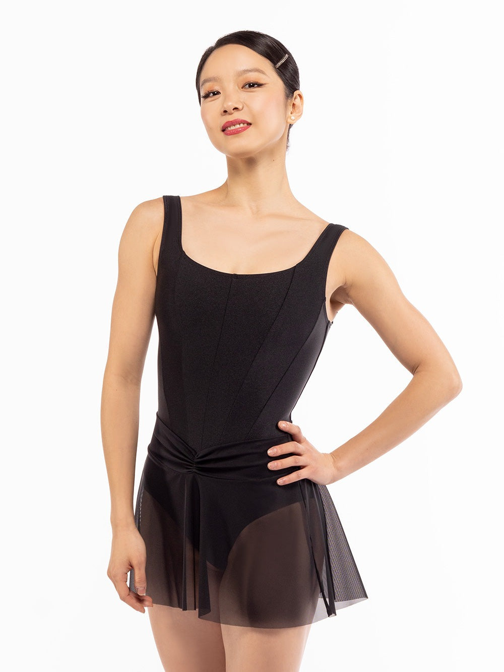 Dancer face front with one hand on the hip, wearing Amora Skirt Black Mesh RTW.