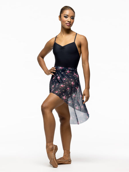 Model is wearing black ballet bodysuit with high low navy blue and pink floral print mesh skirt.