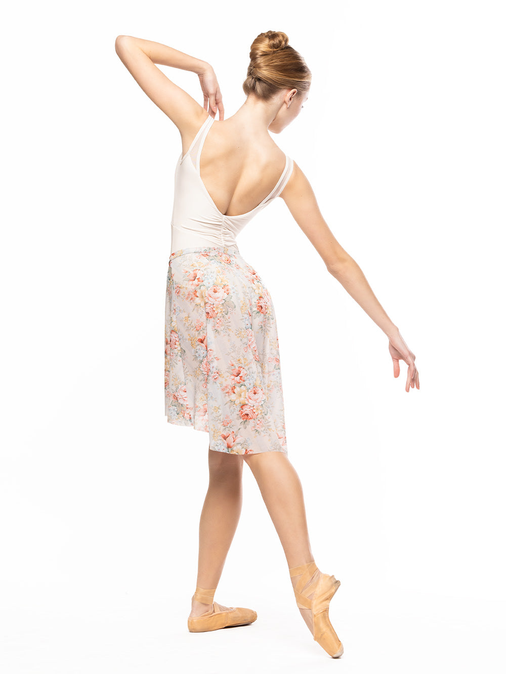 Dancer is facing diagonal back on tendu crossed derriere with one arm on the side to the shoulder on epaulement opposite to the tendu leg, wearing a Long High-Low Skirt Endless Love Mesh RTW.