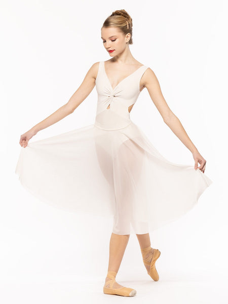 Dancer is facing front on tendu derriere holding the skirt side by side, wearing a Circle Skirt Cream Mesh RTW.