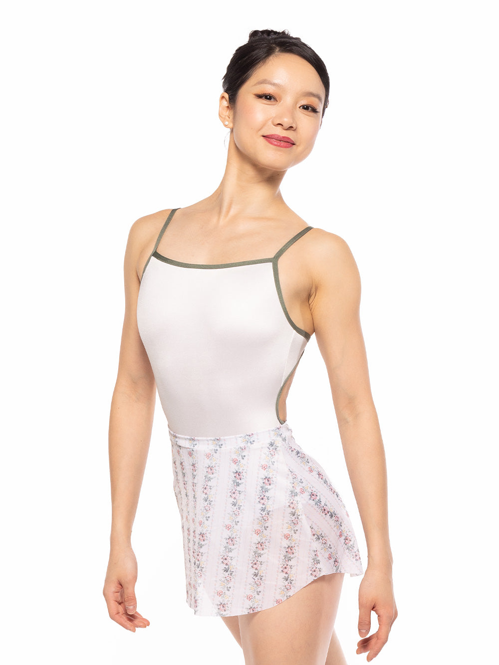 Dancer is facing front with arms relaxed and legs crossed, wearing a Candy Leotard Cream RTW.