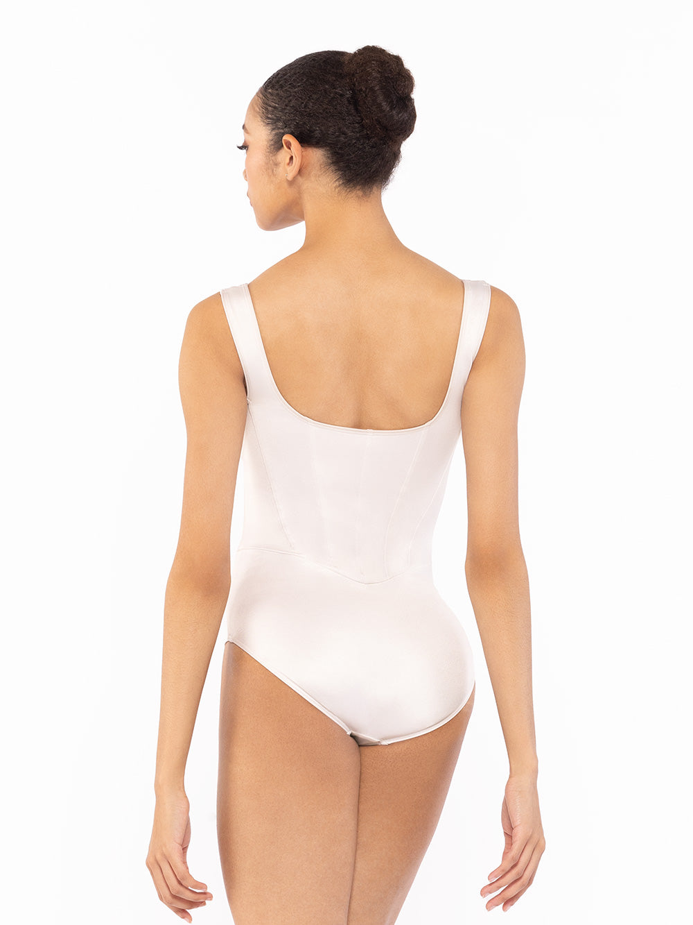 Dancer is facing back with both hands relaxed down, wearing a Cream-Shiny-Diana-4628.