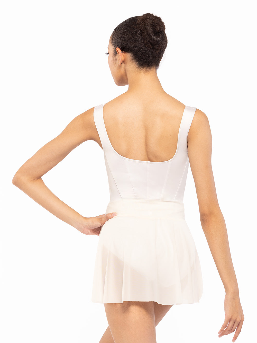 Dancer is facing back with one hand on the hip, wearing a Diana Leotard Cream RTW.
