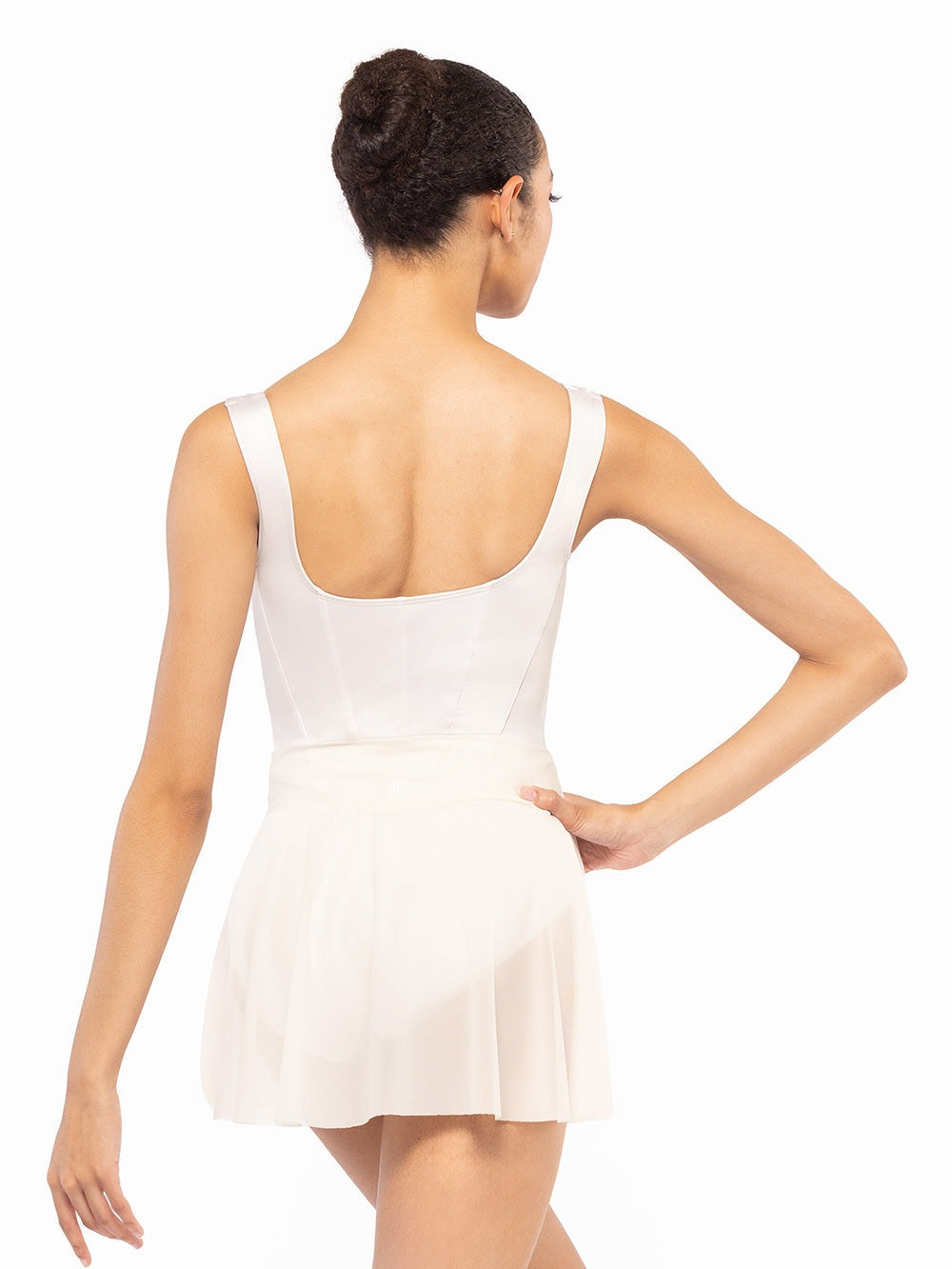 Dancer is facing back with one hand on the hip, wearing a Amora Skirt Cream Mesh RTW.