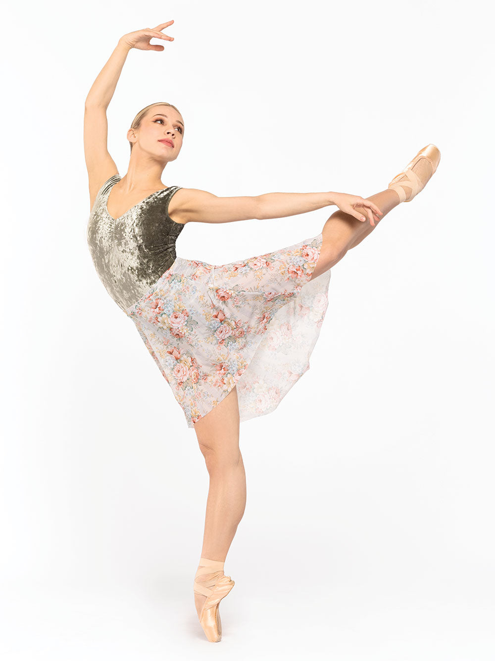 Dancer is profile in first arabesque high position on point with supporting leg arm on fifth and the other epaulement back, wearing a Long High-Low Skirt Endless Love Mesh RTW.