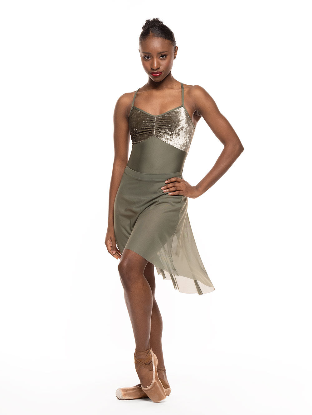 Dancer is facing front with one arm on the hip and one leg on point resting close, wearing a Back Tuck Skirt Dusty Olive Mesh RTW.