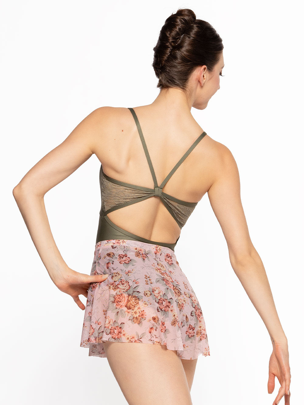 Dancer is facing back with one hand on the hip, wearing a Flare Skirt Love Letter Mesh RTW.