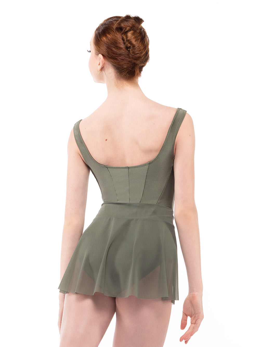 Dancer is facing back on tendu derriere with arms relaxed down, wearing a Diana Leotard Dusty Olive RTW.