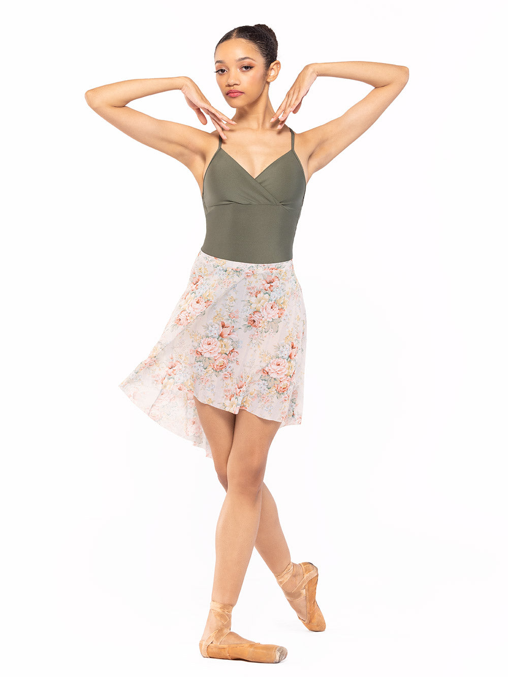 Dancer is facing front with both arms on the side to the shoulders with one leg on cou-de-pie flat derriere, wearing a Long High-Low Skirt Endless Love Mesh RTW.