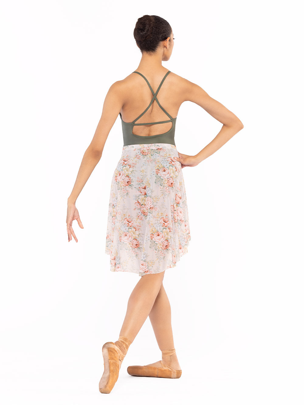 Dancer is facing back with one arm on the hip and cou-de-pie flat derriere, wearing a Long High-Low Skirt Endless Love Mesh RTW.