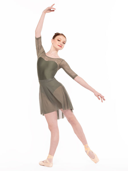 Dancer is profile but facing front on tendu derriere and one arm on fifth and the other extended back, wearing a Back Tuck Skirt Dusty Olive Mesh RTW.