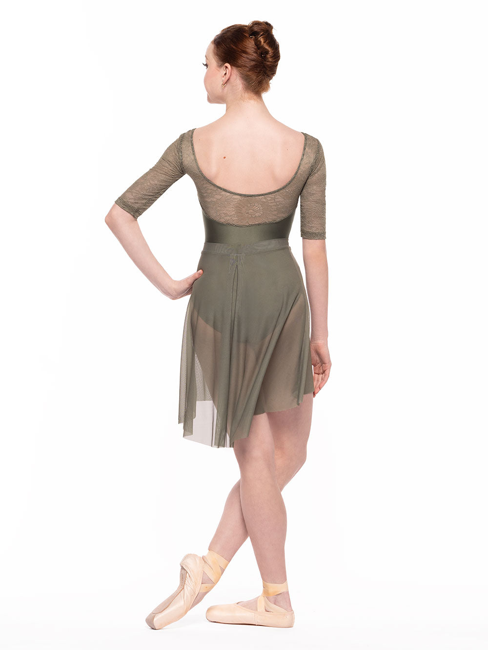 Dancer is facing back with one hand on the hip and one leg wrapped around the other one in front, wearing a Back Tuck Skirt Dusty Olive Mesh RTW.