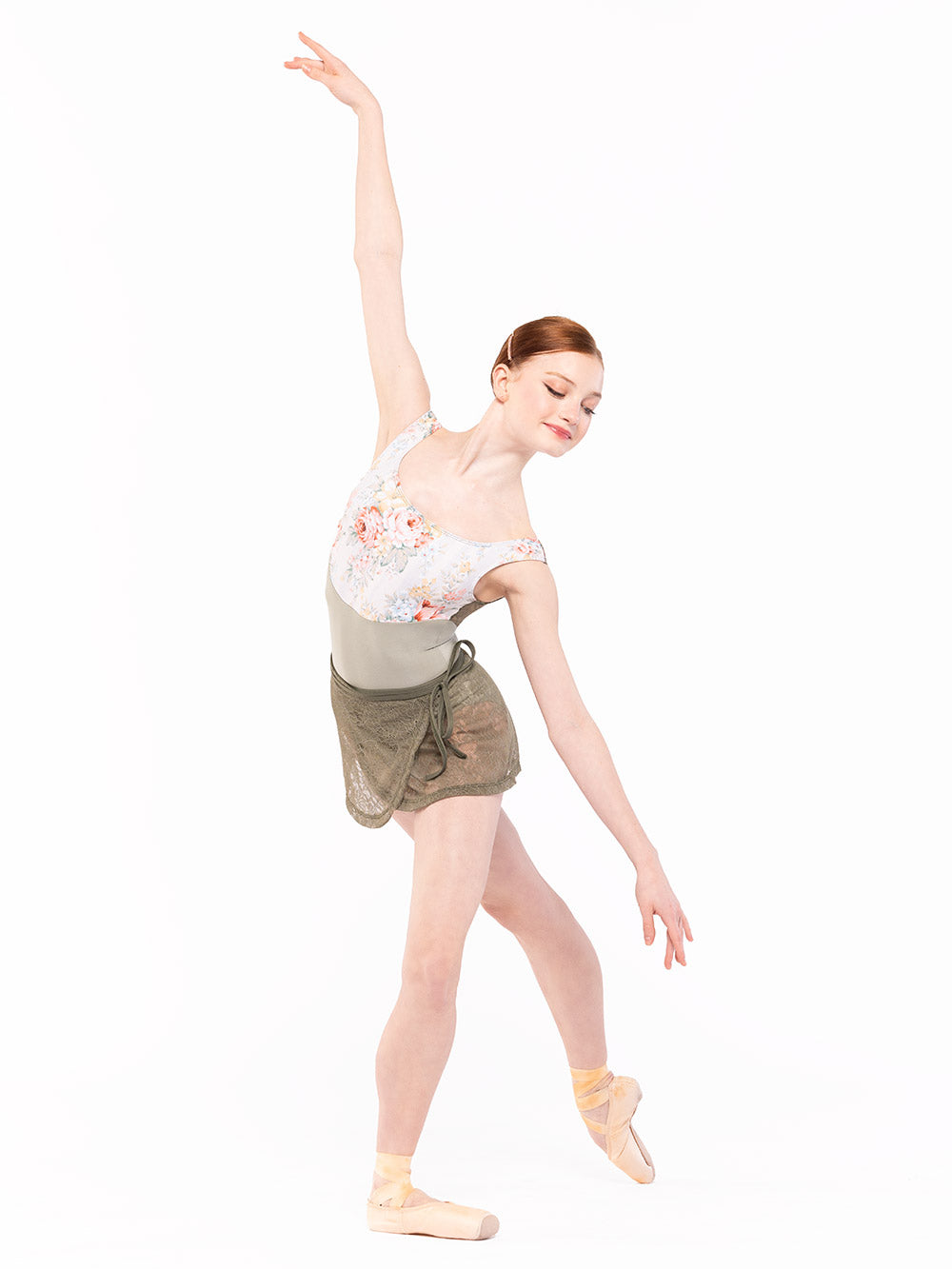 Dancer is on plie front and tendu crossed derriere with epaulement arms, wearing a Audrey Leotard Endless Love RTW.