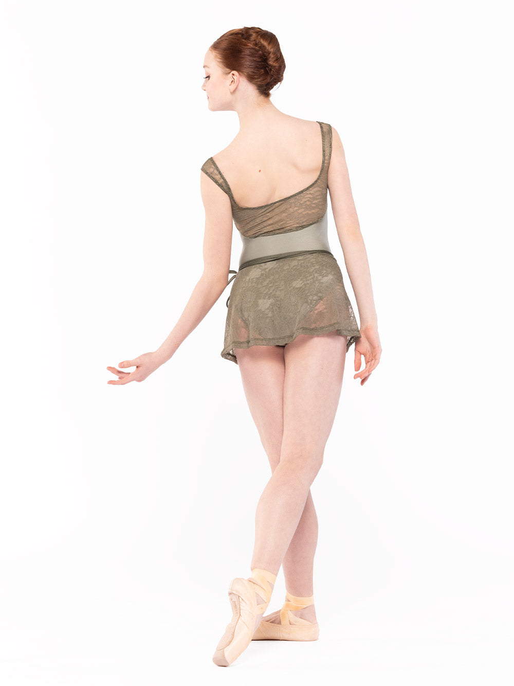 Dancer is facing back with one arm on the side palm up and one leg on cou-de-pie derriere flat, wearing a Audrey Leotard Endless Love RTW.