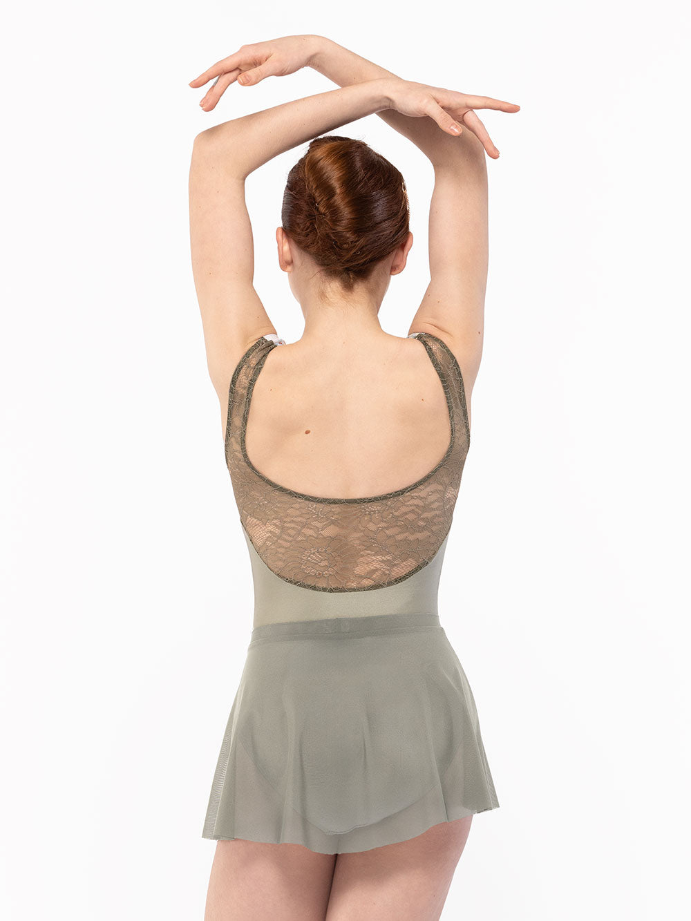 Dancer is facing back with both arms crossed over the head, wearing a Flare Skirt Mercury Mesh RTW.