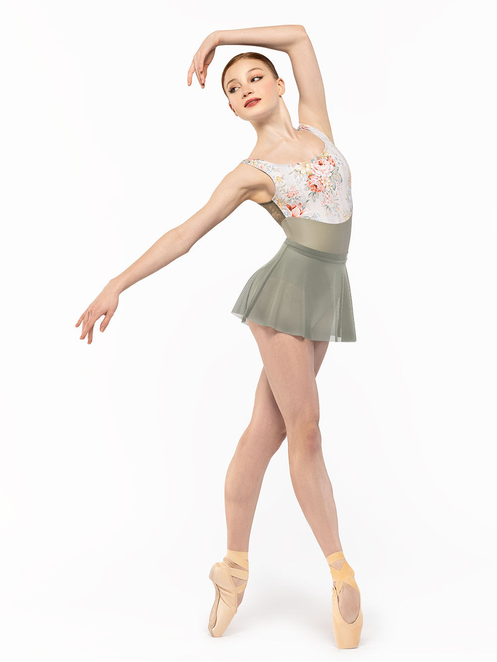 Facing diagonal front in four position on point and arms around and over the head and the other a la seconde, dancer is wearing a Audrey Leotard Endless Love RTW.