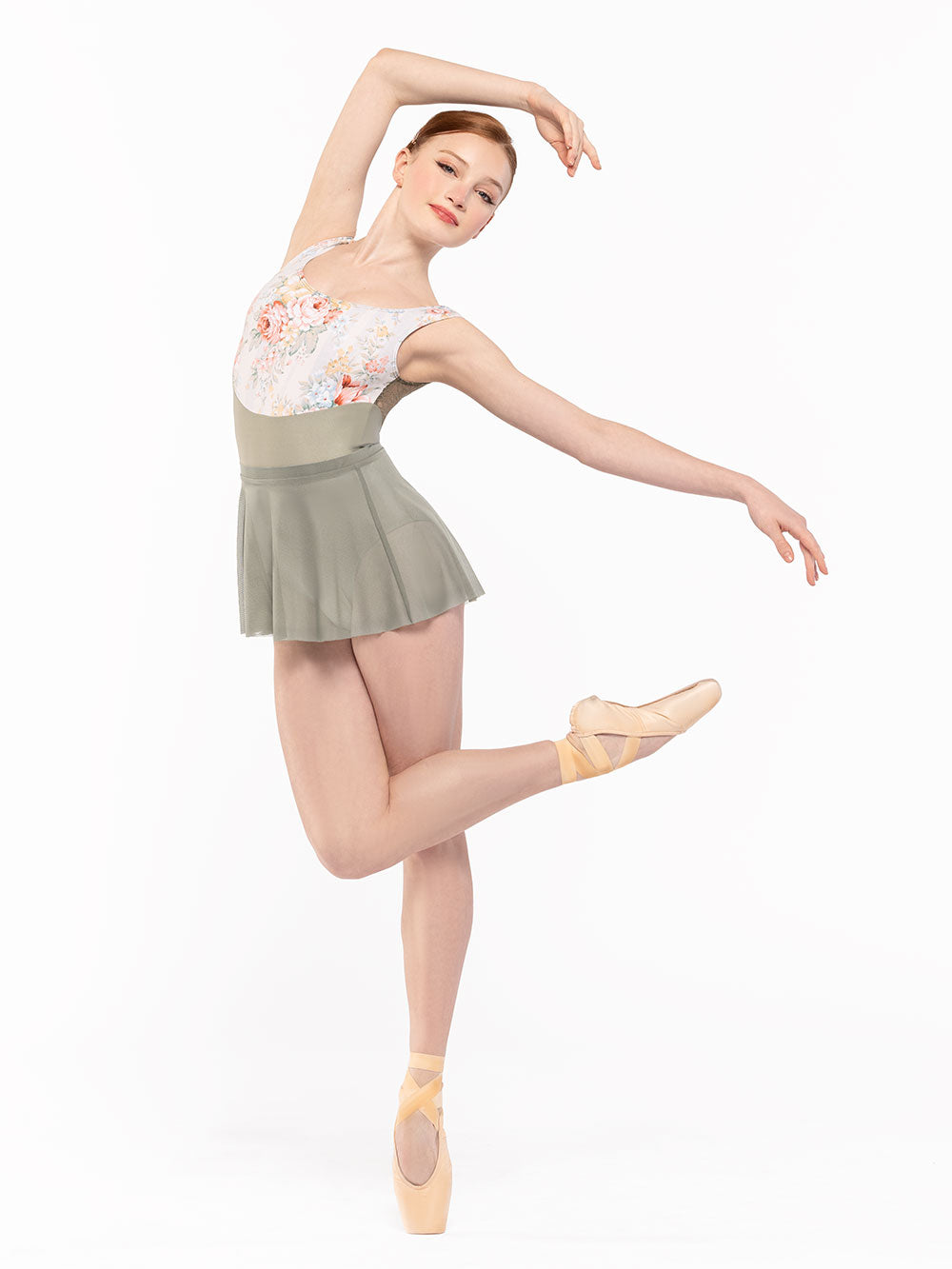 Dancer is facing diagonal front with one leg on point and the other one crossed in passe endedans with arms around and over the head and the other a la seconde, wearing a Audrey Leotard Endless Love RTW.