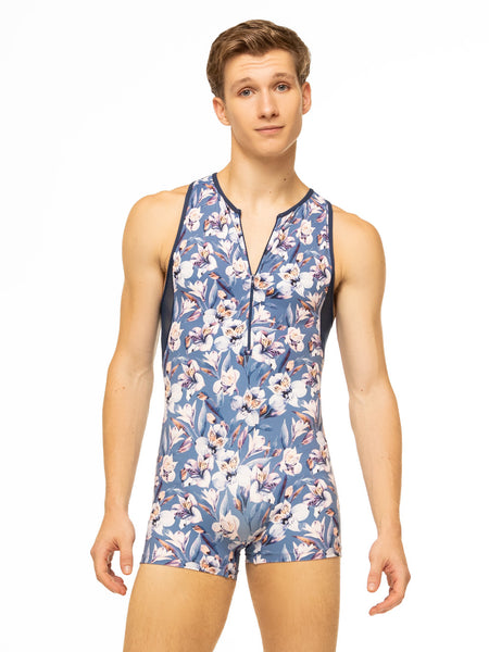 Model is wearing blue floral print men's activewear onesie with zipper front and navy blue mesh back.