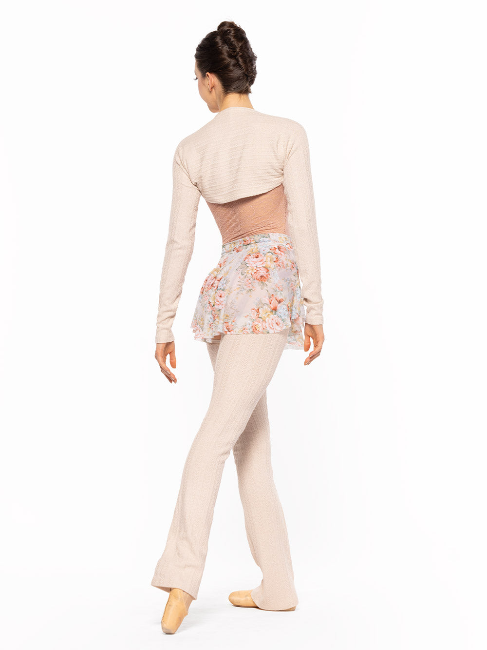 Dancer is facing back on tendu derriere, wearing a Ida Leotard Rosewater Lace RTW.