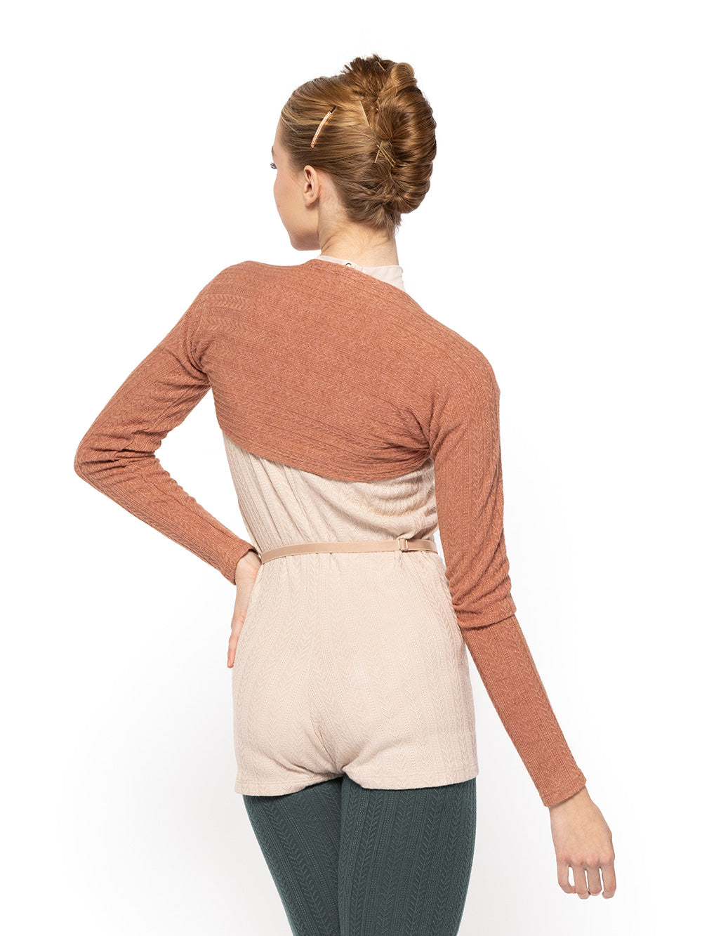 Dancer is facing backwards, wearing a Knit Simone Shortie Oat Thigh High leg warmers Forest Shrug Sandstone RTW.