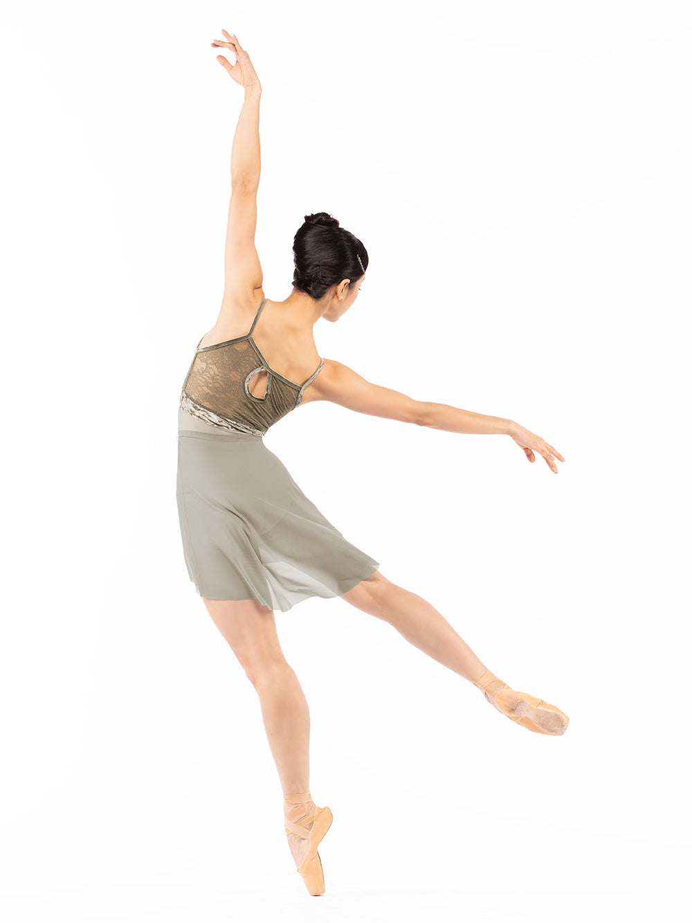 Dancer is facing back but on a leaning forward four arabesque on point with extended arms up and back, and is wearing a Ella Leotard Mercury Dusty Olive Lace RTW.