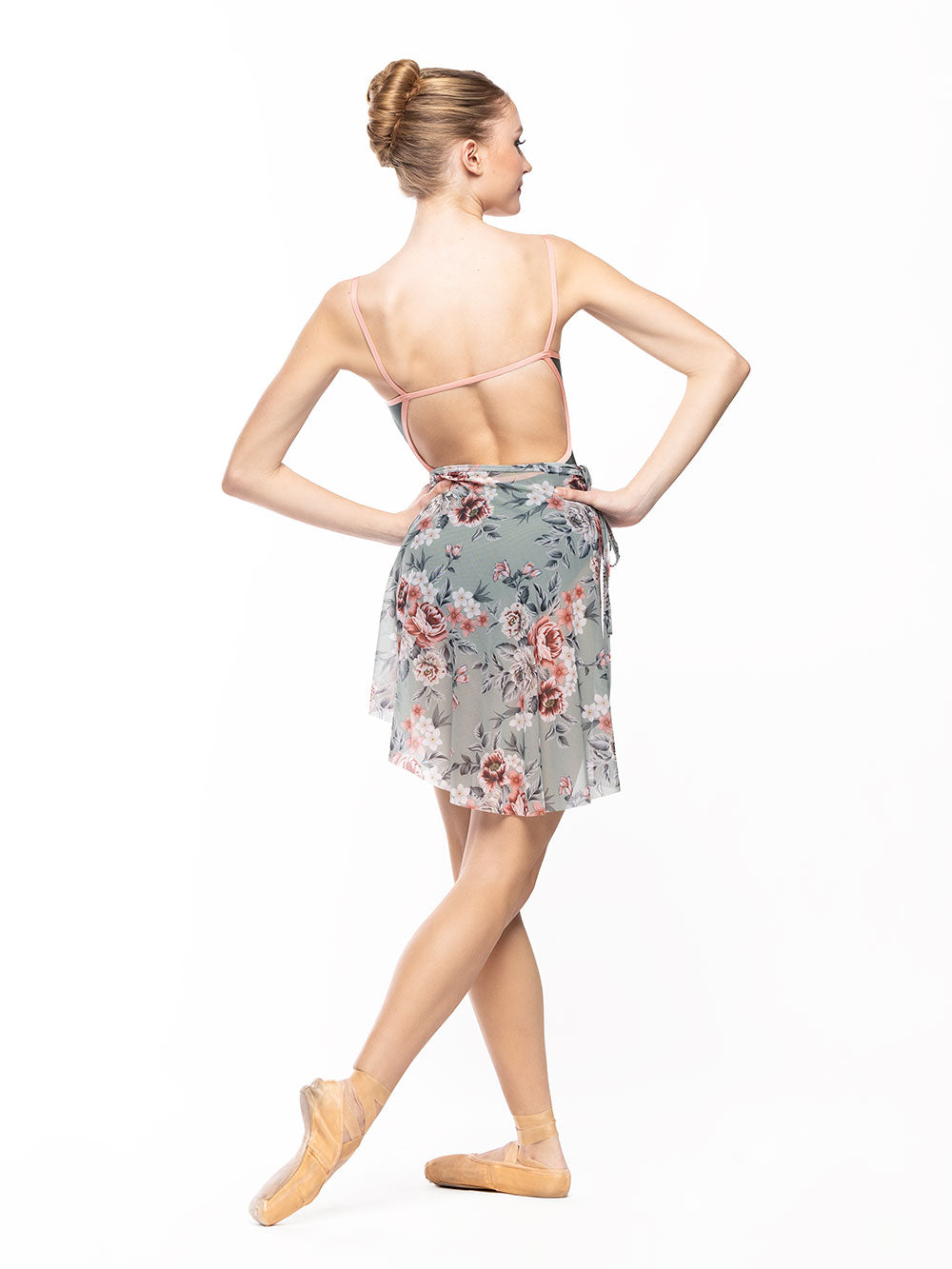 Dancer is facing back with both hands on the hips and on cou-de-pie flat derriere, wearing a Candy Leotard Plate Cacti RTW.