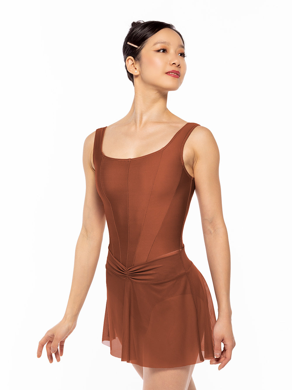 Dancer is wearing Diana Leotard Spice RTW, and facing diagonal front with arms relaxed down.