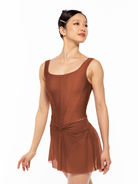 Dancer is facing diagonal front with arms resting down, wearing a Amora Skirt Spice Mesh RTW.