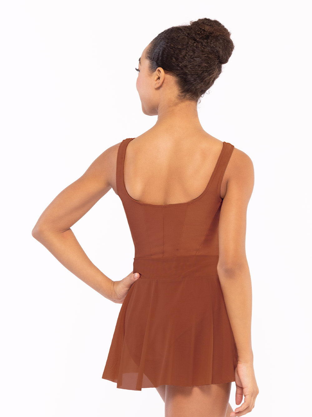 Dancer is facing back with one arm to the hip, wearing a Amora Skirt Spice Mesh RTW.