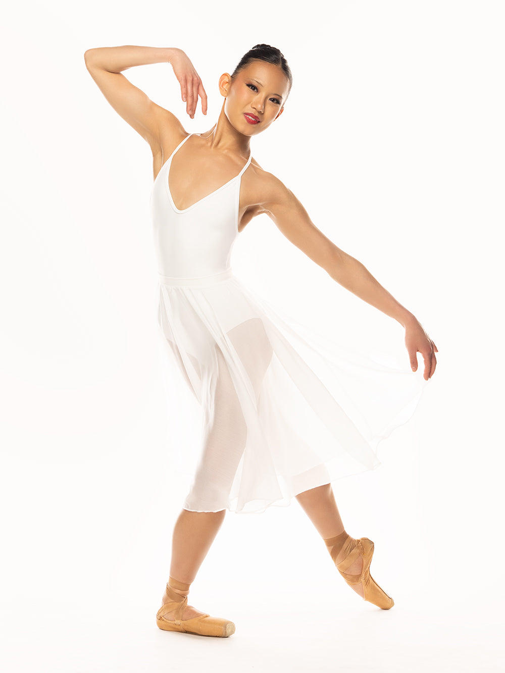 Eleve Dancewear Chiffon Rehearsal Skirt Stage Kids in White color, front view of dancer posing in plie with tendu derriere croise.