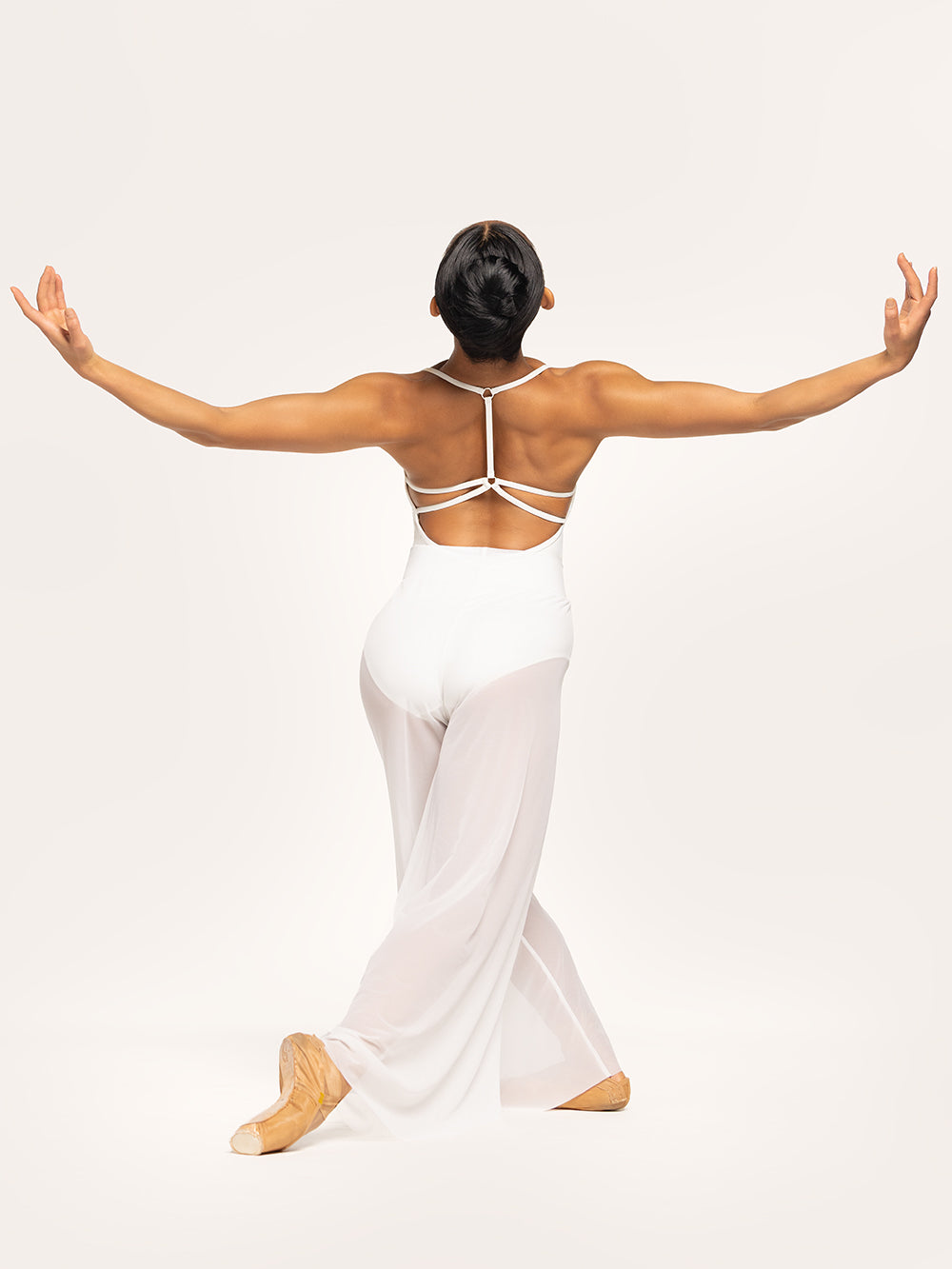 Eleve Dancewear Iris Leotard in Stage White color and A Line Pants in white mesh color with back view of model posing.