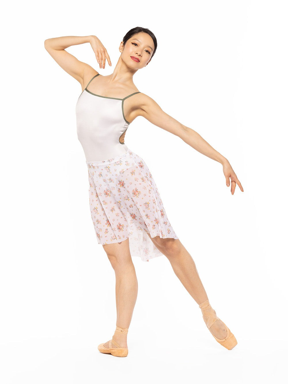 Dancer is profile on tendu derriere and one arm on the shoulder, wearing a Candy Leotard Cream RTW.