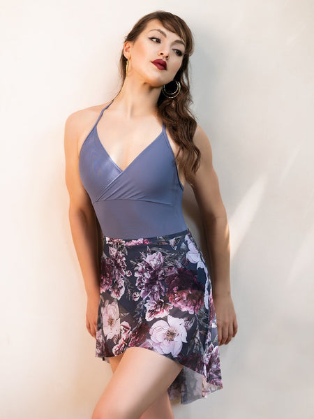 Model wearing a purple leotard with a matching floral mesh pattern skirt