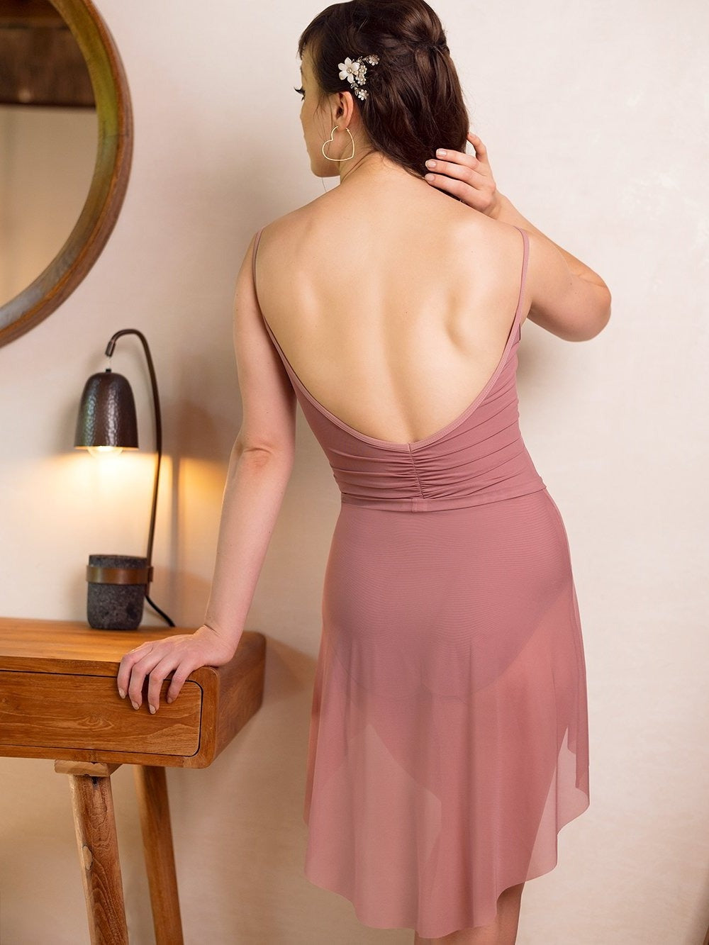 Model wearing dark pink leotard with matching Dark pink skirt