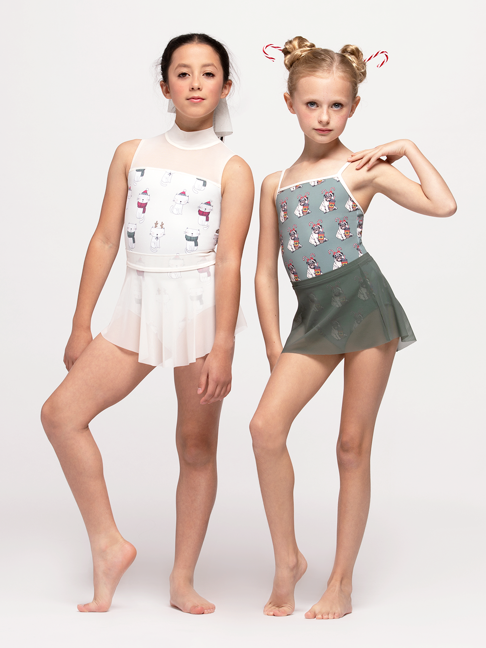 two models - one in white mesh skirt and cat leotard the other in sage green mesh skirt and pug and coffee cup leotard