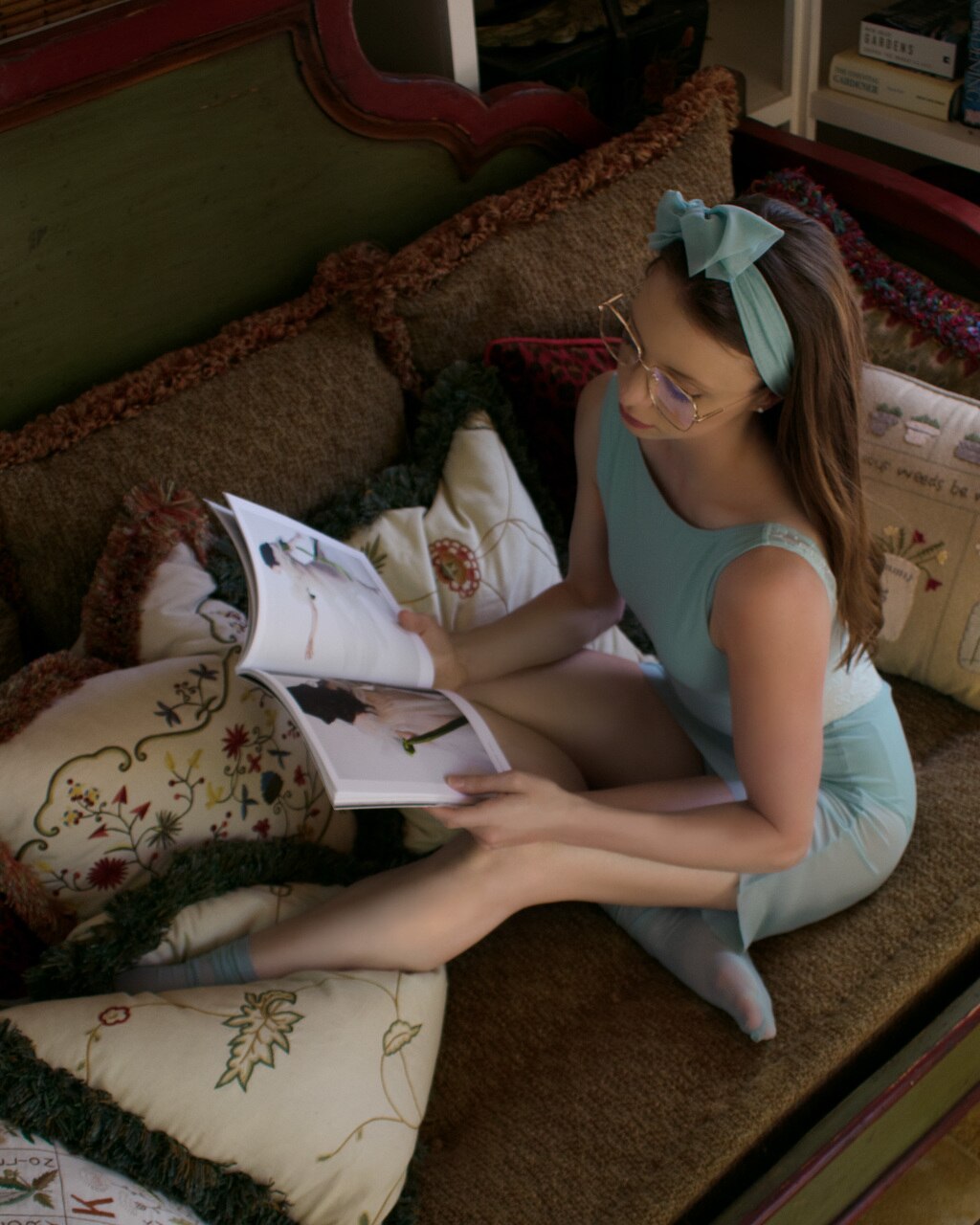 Model wearing a light blue leotard with a matching mesh skirt