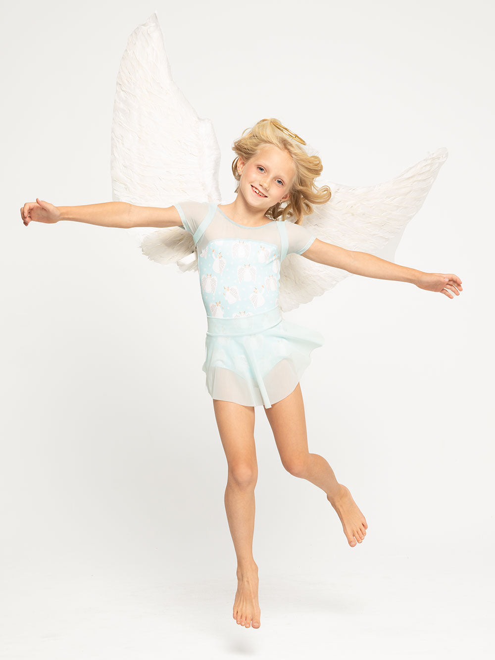 Model is in Angel print leotard with mesh shoulders and matching mesh skirt