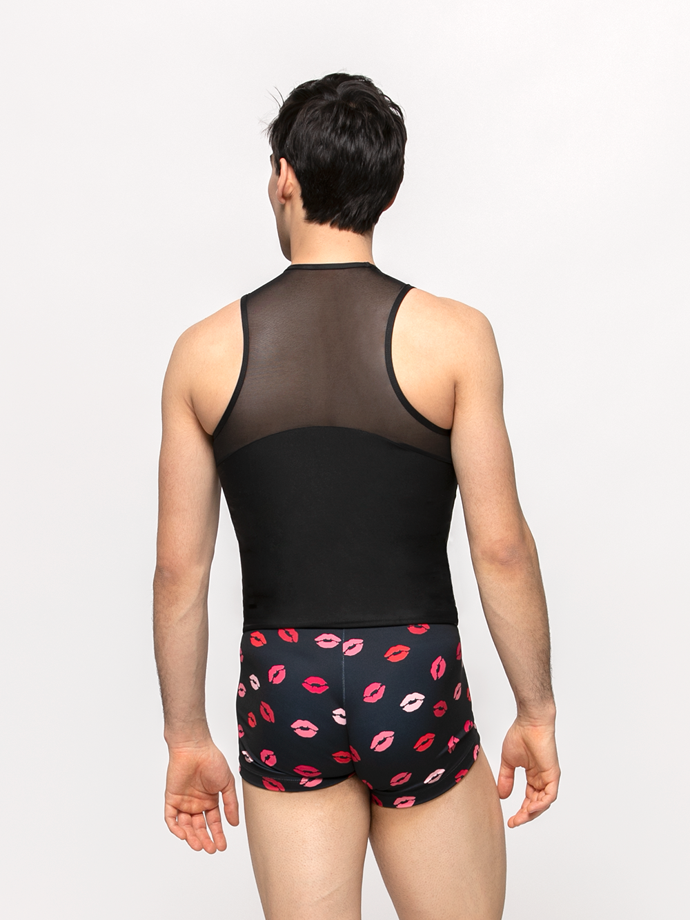 Model showcasing back of tight dance shirt with mesh detail