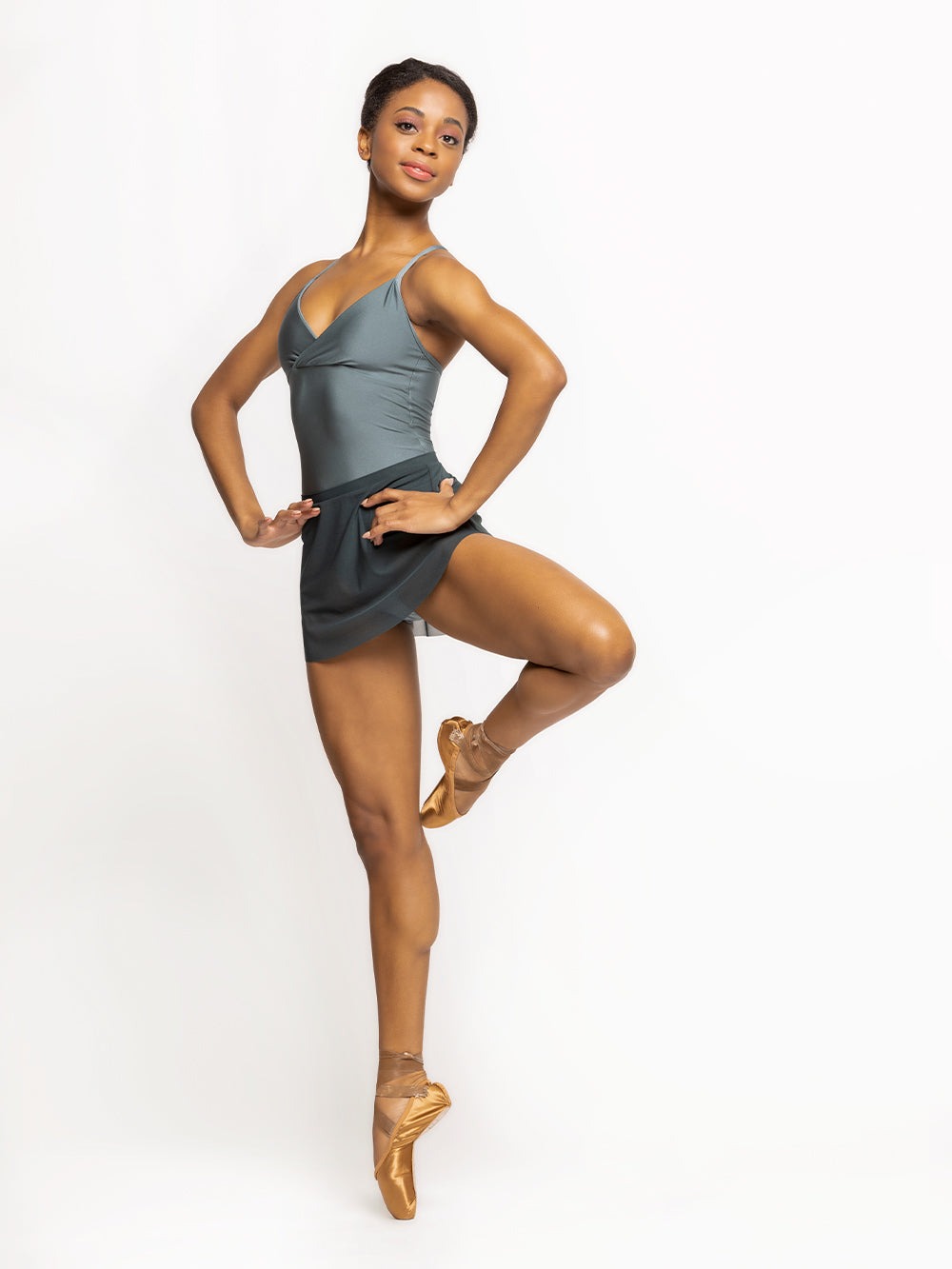 Model is in Shiny blue Agave Leotard and dark blue mesh skirt