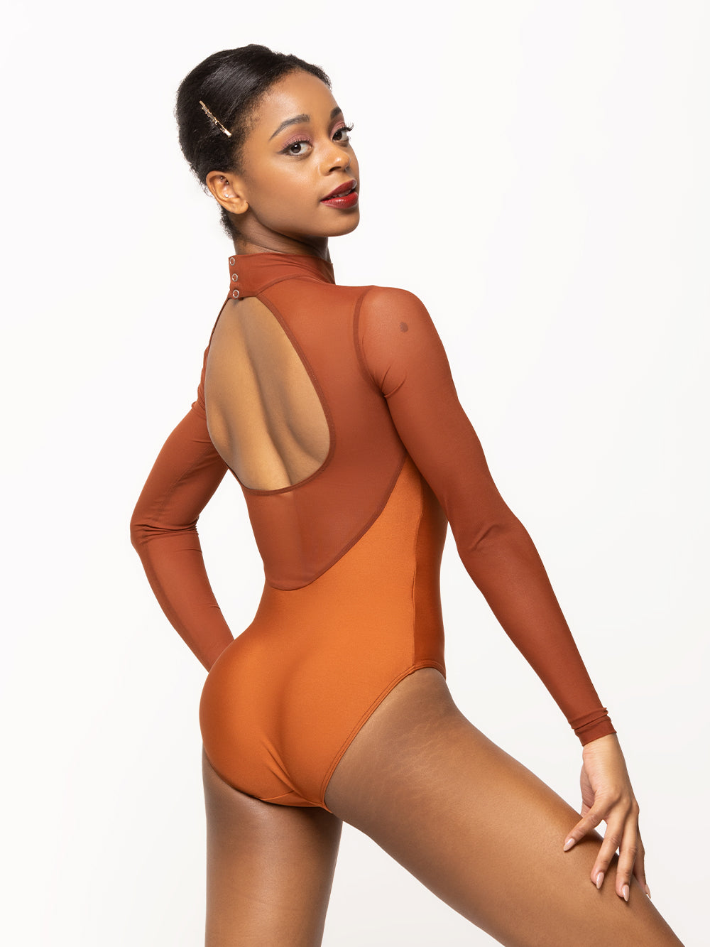 Back of model wearing a shiny Copper orange leotard with Picante orange mesh sleeves, high neck, and open back