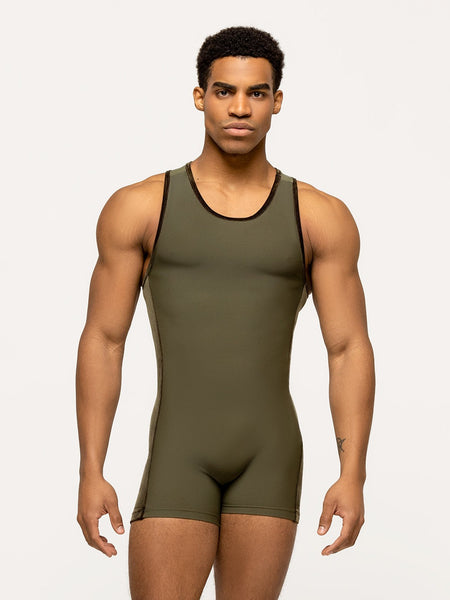 Model is wearing dark olive green short unitard with olive velvet trim and side panel