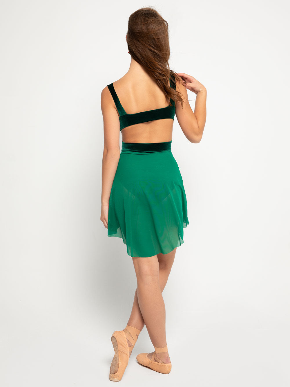 Model in velvet green peak a boo back leotard with green mesh skirt