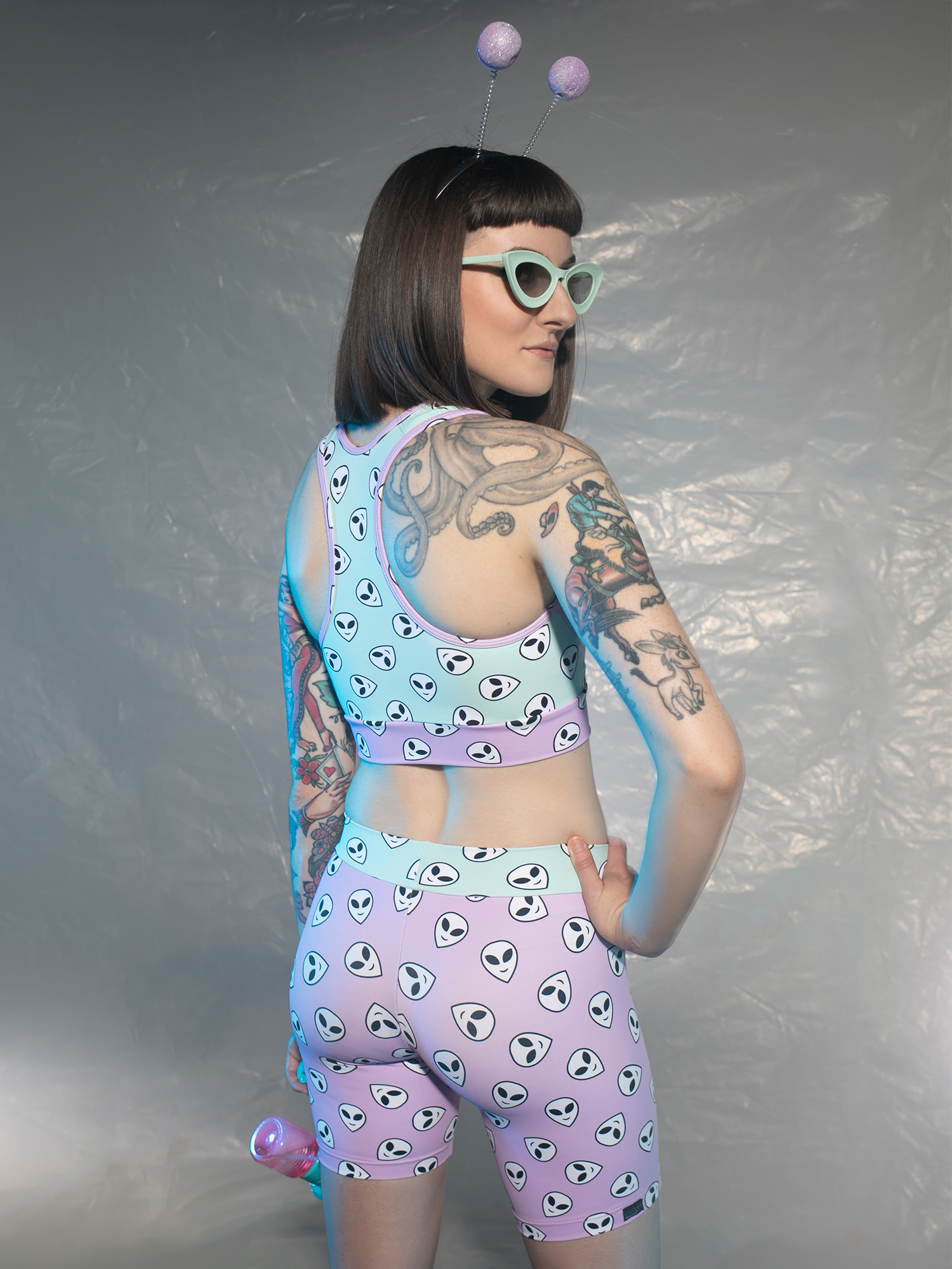 one third back view of women model in crop top and shorts