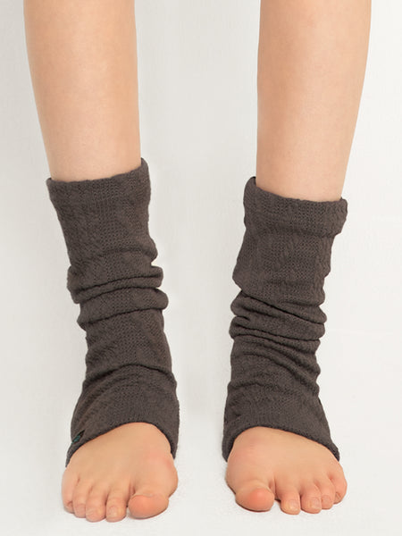 Modal is in ankle light knitted leg warmers in charcoal