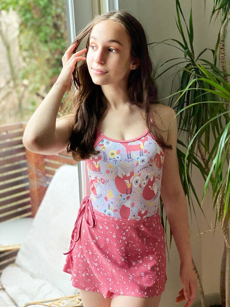 Model wearing a fox pattern leotard with a matching pink floral wrap skirt